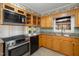 Updated kitchen with wood cabinets, granite counters and stainless steel appliances at 739 Silk Hope Lindley Mill Rd, Siler City, NC 27344