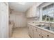 Laundry room offers ample cabinetry and a double sink at 739 Silk Hope Lindley Mill Rd, Siler City, NC 27344
