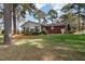 Brick home with sunroom and mature landscaping at 739 Silk Hope Lindley Mill Rd, Siler City, NC 27344