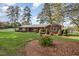 Brick ranch house with a well-manicured lawn and mature trees at 739 Silk Hope Lindley Mill Rd, Siler City, NC 27344