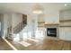 Living room with hardwood floors, fireplace, and built-in shelving at 2305 Eddie Howard Rd, Willow Springs, NC 27592
