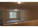 Bright bonus room with large window and neutral decor at 3565 Kirkland Ct # 108, Burlington, NC 27217