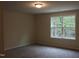 Spacious bedroom with large window and carpet at 3565 Kirkland Ct # 108, Burlington, NC 27217