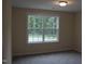 Well-lit bedroom with large window overlooking trees at 3565 Kirkland Ct # 108, Burlington, NC 27217