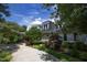 White farmhouse with stone accents and landscaping at 1153 Four Wheel Dr, Wake Forest, NC 27587