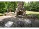 Stone patio with a built-in fireplace and seating area at 1153 Four Wheel Dr, Wake Forest, NC 27587