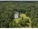 Aerial view of house, pool, and expansive green lawn nestled in a wooded area at 1153 Four Wheel Dr, Wake Forest, NC 27587