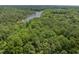 Aerial view of a vast wooded area with a lake at 1153 Four Wheel Dr, Wake Forest, NC 27587
