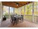 Relaxing screened porch with wood decking, wicker furniture, and scenic wooded views at 109 Creekvista Dr, Holly Springs, NC 27540