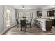 Dining area with glass-top table, four chairs, and access to kitchen at 96 Abram Ct, Broadway, NC 27505