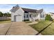 White house with a dark door, attached garage, and a small front porch at 96 Abram Ct, Broadway, NC 27505
