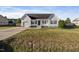 White house with a dark door, attached garage, and a small front porch at 96 Abram Ct, Broadway, NC 27505