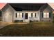 Gray and white house with a dark door, attached garage, and a small front porch at 96 Abram Ct, Broadway, NC 27505