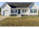White house with gray shutters, attached garage, and a small front porch at 96 Abram Ct, Broadway, NC 27505