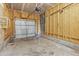 Unfinished garage with overhead door and concrete floor at 96 Abram Ct, Broadway, NC 27505
