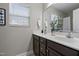 Double vanity bathroom with dark brown cabinets and a large mirror at 96 Abram Ct, Broadway, NC 27505