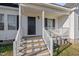Small front porch with white railings and a dark door at 96 Abram Ct, Broadway, NC 27505