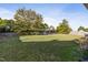 Large backyard with grass, a tree, and a swing set at 96 Abram Ct, Broadway, NC 27505