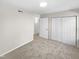 Bedroom with double-door closet and access to hallway at 1122 E Ellerbee St, Durham, NC 27704