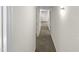 Long hallway with carpeted floor and access to multiple rooms at 1122 E Ellerbee St, Durham, NC 27704