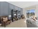 Bright living room featuring a large window, comfy seating, and stylish shelving at 1510 Village Hall Ln # 44, Wake Forest, NC 27587