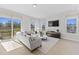Bright and airy living room with large windows, a sectional sofa, and access to deck at 1510 Village Hall Ln # 44, Wake Forest, NC 27587