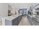Modern kitchen with stainless steel appliances and a large island at 1510 Village Hall Ln # 44, Wake Forest, NC 27587