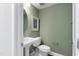 Small powder room with a pedestal sink and fresh green paint at 1510 Village Hall Ln # 44, Wake Forest, NC 27587