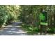 Paved walking trail through a wooded area with regulations sign at 1510 Village Hall Ln # 44, Wake Forest, NC 27587