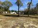 Spacious backyard with mature trees and a view of the house at 130 Wiltshire Dr, Clayton, NC 27527