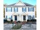 Two-story townhome with neutral siding, shutters, and a paved driveway at 2129 Ventana Ln, Raleigh, NC 27604