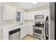 Kitchen with white cabinets, stainless steel appliances and view of backyard at 2129 Ventana Ln, Raleigh, NC 27604