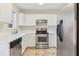 Galley kitchen with white cabinets and stainless steel appliances at 2129 Ventana Ln, Raleigh, NC 27604