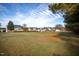 Large grassy yard with a view of homes and trees at 357 Riverwood Dr, Clayton, NC 27527