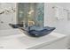 Modern bathroom with a unique blue glass sink and gold fixtures at 505 Colleton Rd, Raleigh, NC 27610