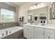 Bathroom with double vanity, soaking tub, and modern fixtures at 2213 Pitchfork Ln, Durham, NC 27713