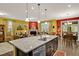 Open concept kitchen with granite island and stainless steel appliances, overlooking dining and living areas at 1203 Lotus Lilly Dr, Durham, NC 27713