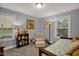 Cozy bedroom with daybed, armchair, and decorative shelving at 1203 Lotus Lilly Dr, Durham, NC 27713