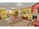 Spacious living room with fireplace, featuring a mix of red and yellow walls at 1203 Lotus Lilly Dr, Durham, NC 27713