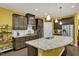 Spacious kitchen with granite island, stainless steel appliances, and dark wood cabinets at 1203 Lotus Lilly Dr, Durham, NC 27713
