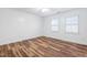 Simple bedroom with wood-look floors and window with blinds at 1321 Dylan Heath Ct, Raleigh, NC 27608
