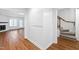 Bright hallway with wood floors and access to living room and stairs at 1321 Dylan Heath Ct, Raleigh, NC 27608