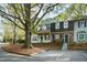 Two-story brick townhouse with a tree-lined street and parking at 1321 Dylan Heath Ct, Raleigh, NC 27608