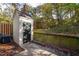 Small storage shed in backyard with wooded backdrop at 1321 Dylan Heath Ct, Raleigh, NC 27608