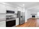 Modern kitchen features stainless steel appliances and granite countertops at 1321 Dylan Heath Ct, Raleigh, NC 27608