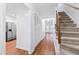 Bright hallway with wood floors, staircase, and closet at 1321 Dylan Heath Ct, Raleigh, NC 27608