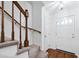 Entryway with staircase, wood floors, and white door at 1321 Dylan Heath Ct, Raleigh, NC 27608