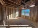 Framed bedroom with windows, showing OSB subflooring and electrical at 1073 Channel Drop Lp, Zebulon, NC 27597