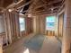 Framed bedroom with windows, showing OSB subflooring and electrical at 1073 Channel Drop Lp, Zebulon, NC 27597