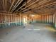 An open floor plan with exposed framing, plumbing, and electrical work at 1073 Channel Drop Lp, Zebulon, NC 27597